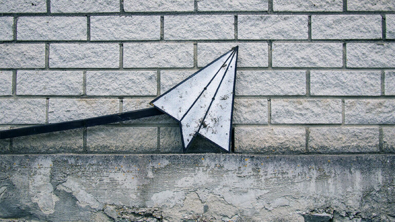 Metallic sculpture of a paper aeroplane